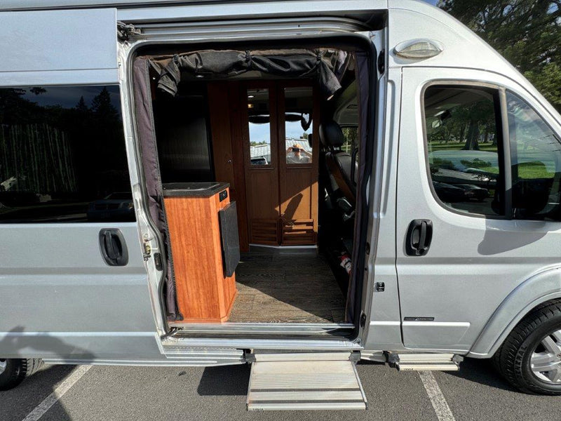  showing its welcoming wood interior.|This RV rental features a compact kitchen with black countertops — photo 6
