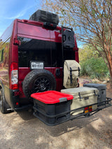 This red RV rental is equipped for adventure with a rear-mounted spare tire, cargo carrier, coolers, and RotopaX.