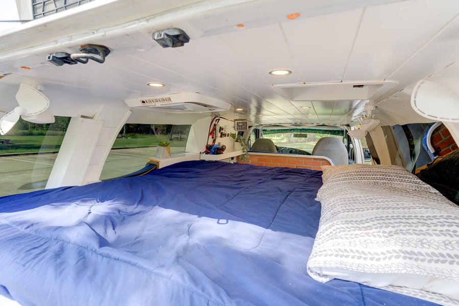  and grill ready for outdoor cooking in a nature setting.|Inside a custom rv rental — photo 4