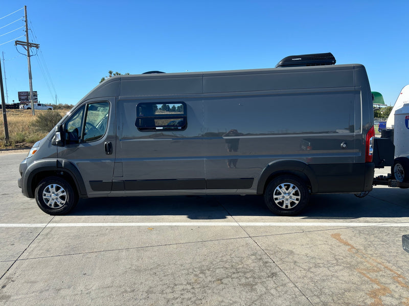 Grey RV rental camper van with a Dometic roof unit, parked on concrete, ready for travel and towing a trailer. — photo 19