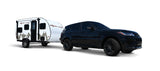 A black Range Rover SUV tows a white Rove Lite teardrop travel trailer, ideal for your next rv rental adventure.