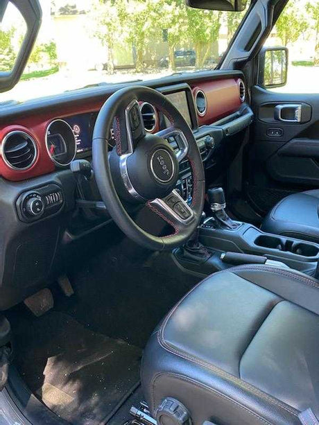 Vehicle interior: black leather seats, red dashboard, steering wheel. Comfort for your road trips or rv rental travel.