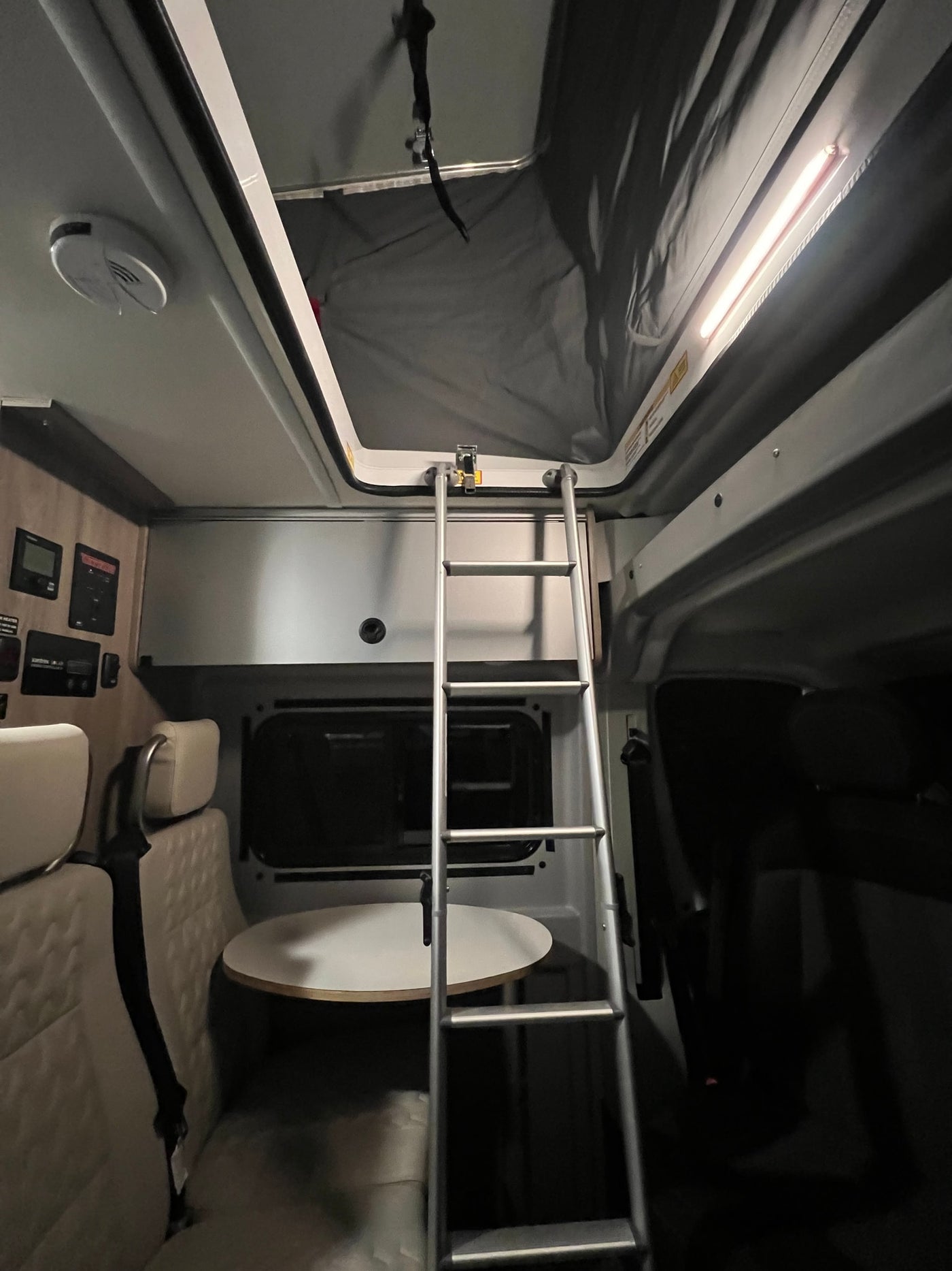 and a starry bed for comfortable travel adventures.|RV rental interior: compact living with driver's cockpit — photo 5