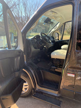 Open driver's door of a spacious RV rental, showing the light seat, steering wheel, and step. Ready for adventure!