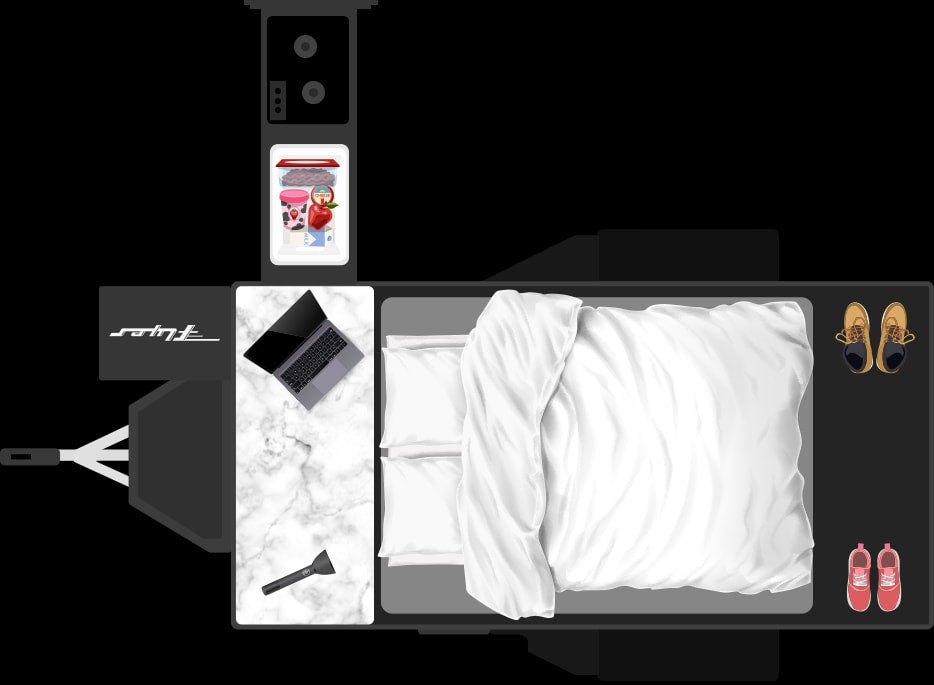 Overhead view of an RV rental interior: bed, counter with laptop, mini-fridge with snacks, and shoes. Compact mobile living.