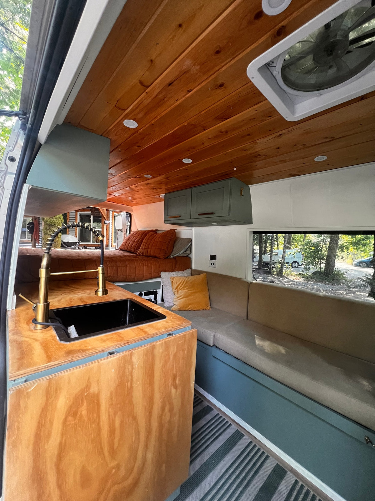 Cozy RV rental interior featuring a wood ceiling