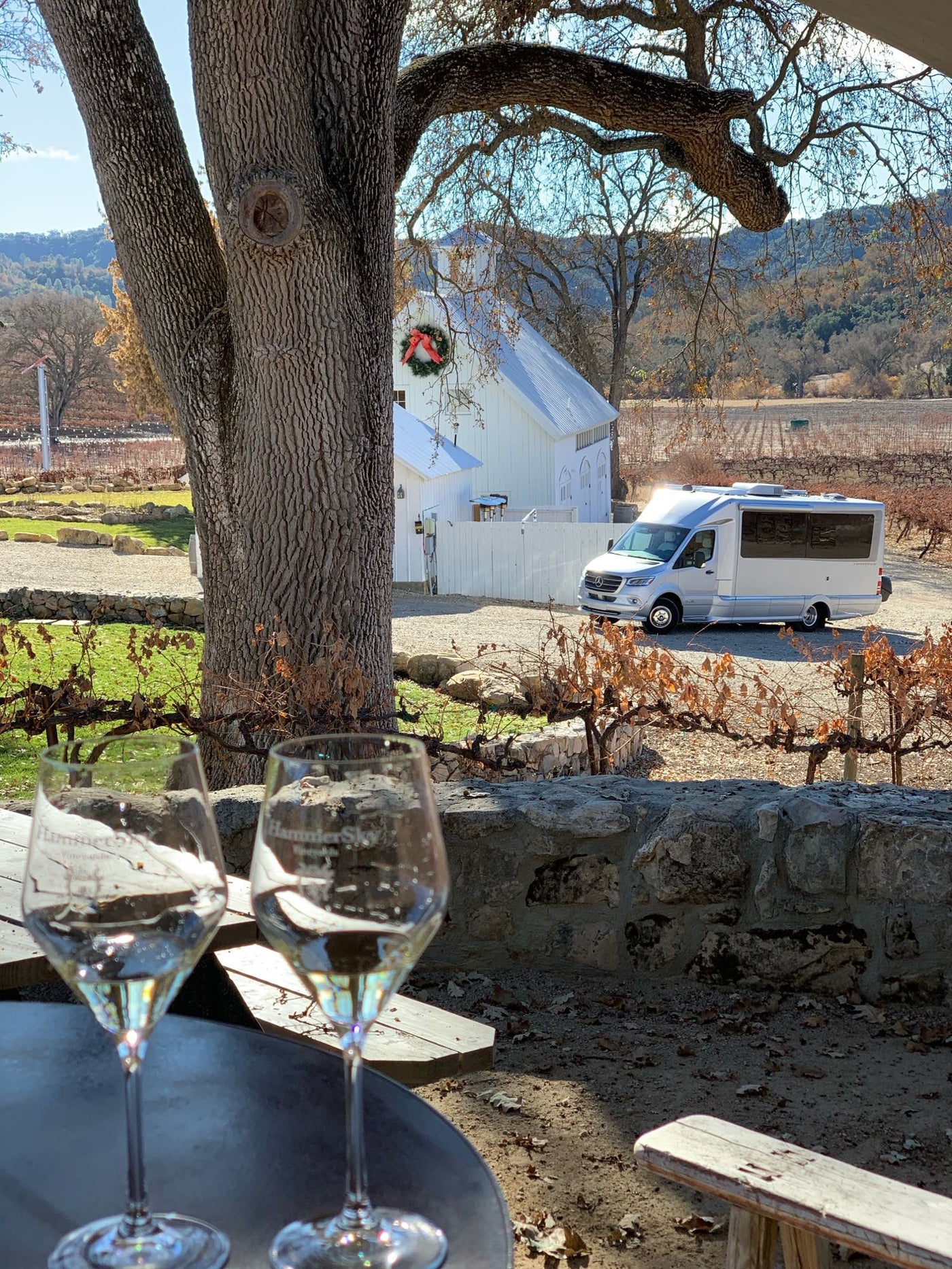  and chairs by crashing ocean waves. People watch the sea.|Sleek RV rental on a desert road at golden hour. See Joshua Trees and mountains. Plan your adventure road trip.|Wine tasting at a scenic vineyard — photo 3