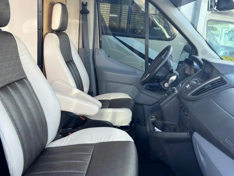 Spacious RV rental interior: two-tone front seats and dashboard, ready for your next adventure.