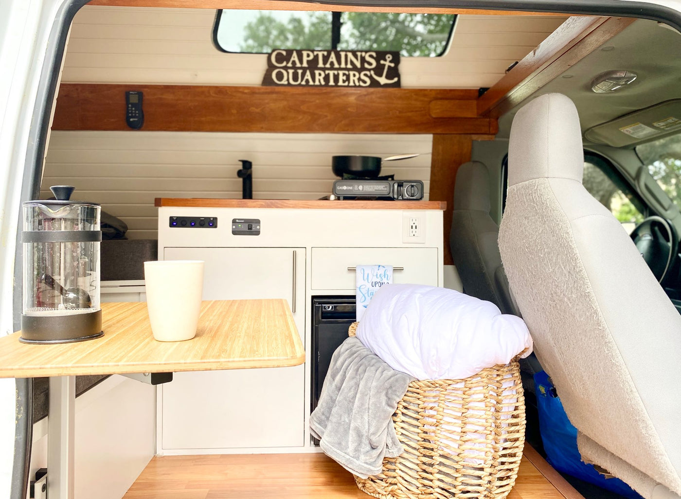  and nautical decor.|An RV rental's compact kitchen with wooden counter — photo 3