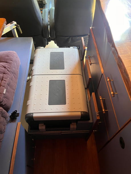 RV rental interior featuring custom cabinetry and two portable fridges for compact living and storage.