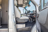 Spacious and modern RV rental interior showing the driver's cabin with a light-colored seat and dashboard.