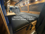 This cozy RV rental features a van interior with seats converting into a spacious bed for 2 adults, complete with a kitchenette.