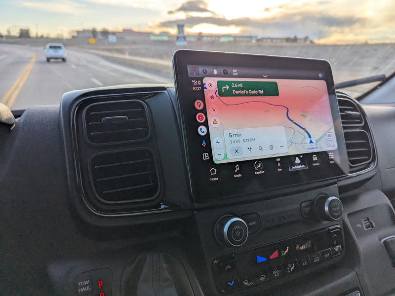 Dashboard of an rv rental, showing Google Maps navigation for Daniel's Gate Rd on the large screen, alongside climate controls. — photo 13