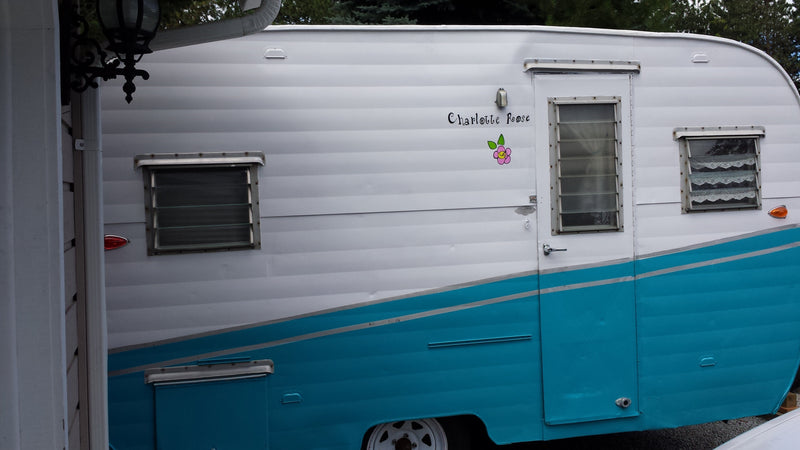 Charming white & turquoise vintage RV rental: a travel trailer named 'Charlotte Roose' with lace curtains. — photo 8