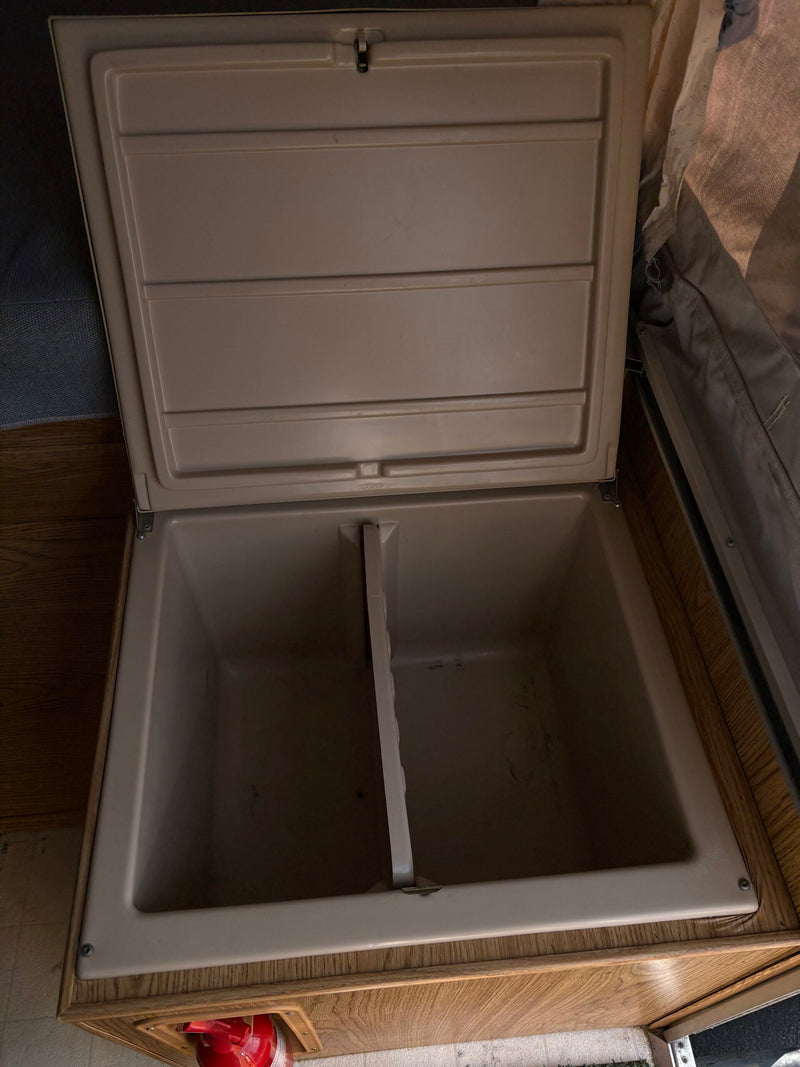 View inside an RV rental's built-in cooler/storage, featuring dual compartments for easy organization. — photo 5