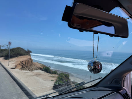 Enjoying a stunning ocean view from an RV rental, complete with a fun disco ball. Ideal for scenic road trips.