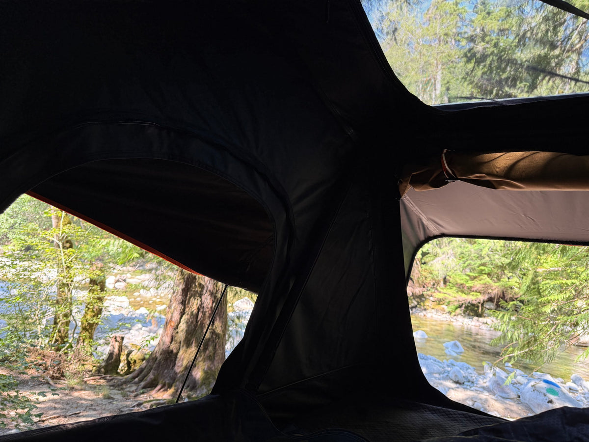  and a light-colored ceiling.|Inside an RV rental's cozy rooftop tent — photo 13