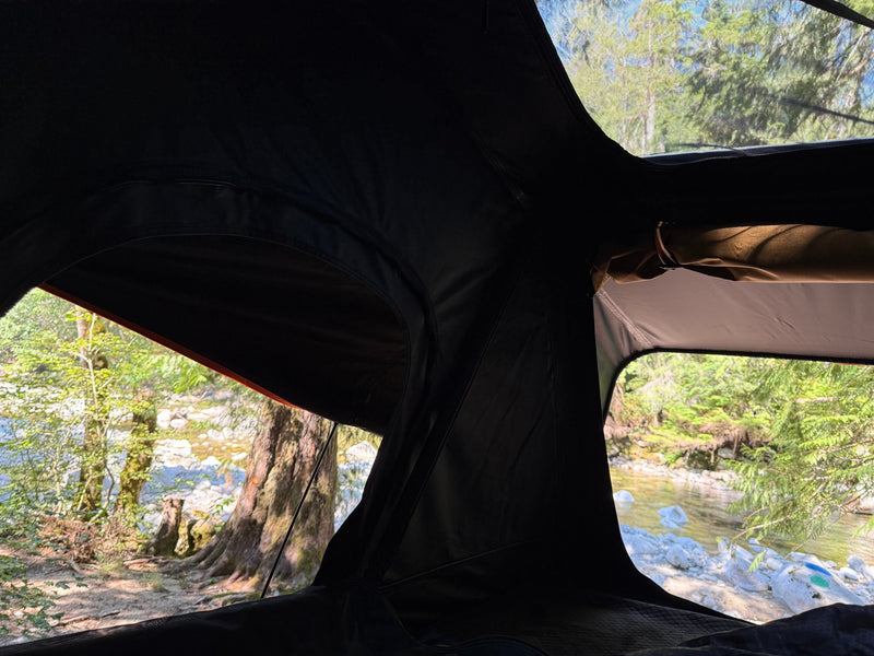  and a light-colored ceiling.|Inside an RV rental's cozy rooftop tent — photo 13
