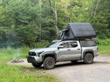  and view out a window.|Interior of an off-road RV rental's rooftop tent