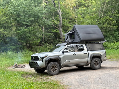  and view out a window.|Interior of an off-road RV rental's rooftop tent