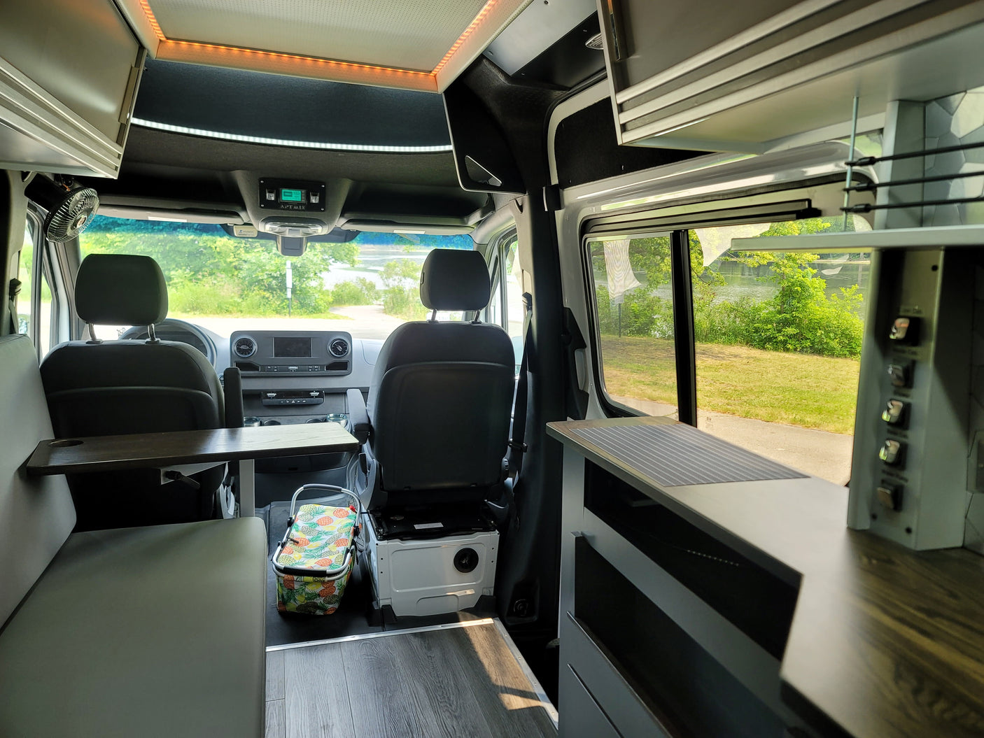 Spacious rv rental camper van interior with seating, kitchen, and scenic views for mobile living.