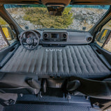 This RV rental transforms! An air mattress fills the front cabin of this van, offering a cozy bed for van life and camping trips.