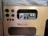 This RV rental features a VanLab power control panel: an inverter, USB & AC outlets, 12V sockets, and voltage displays for mobile power.