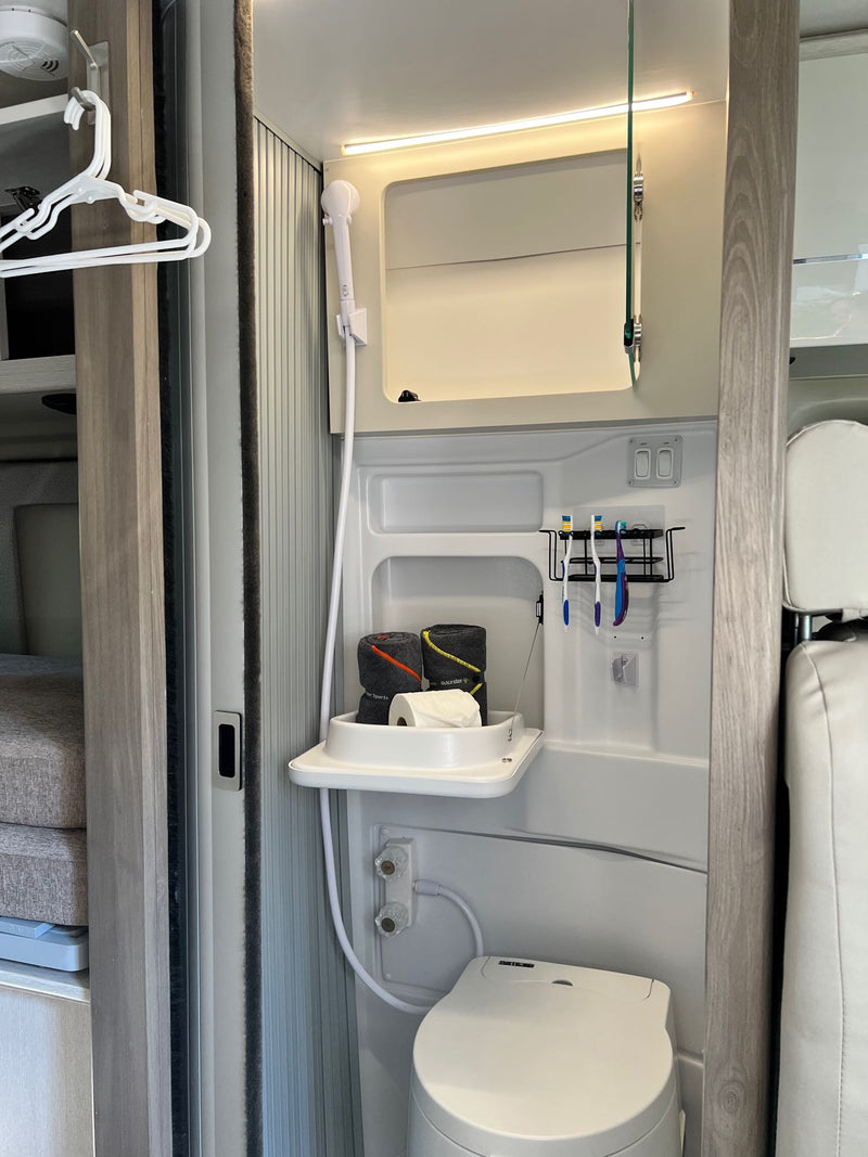  and Winegard mobile internet system for your adventures.|Spacious rv rental interior featuring a practical dining table with place settings — photo 13