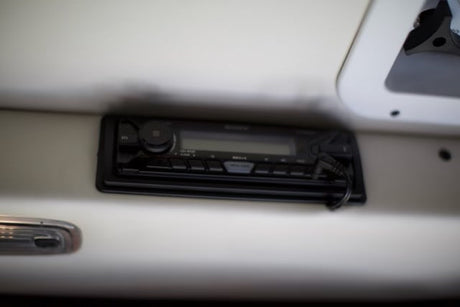 A mounted Sony car stereo with AUX cable plugged in provides entertainment for an RV rental.