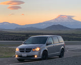 Gray minivan for scenic trips, an alternative to an RV rental. Stunning lenticular clouds over snowy mountains at sunset.