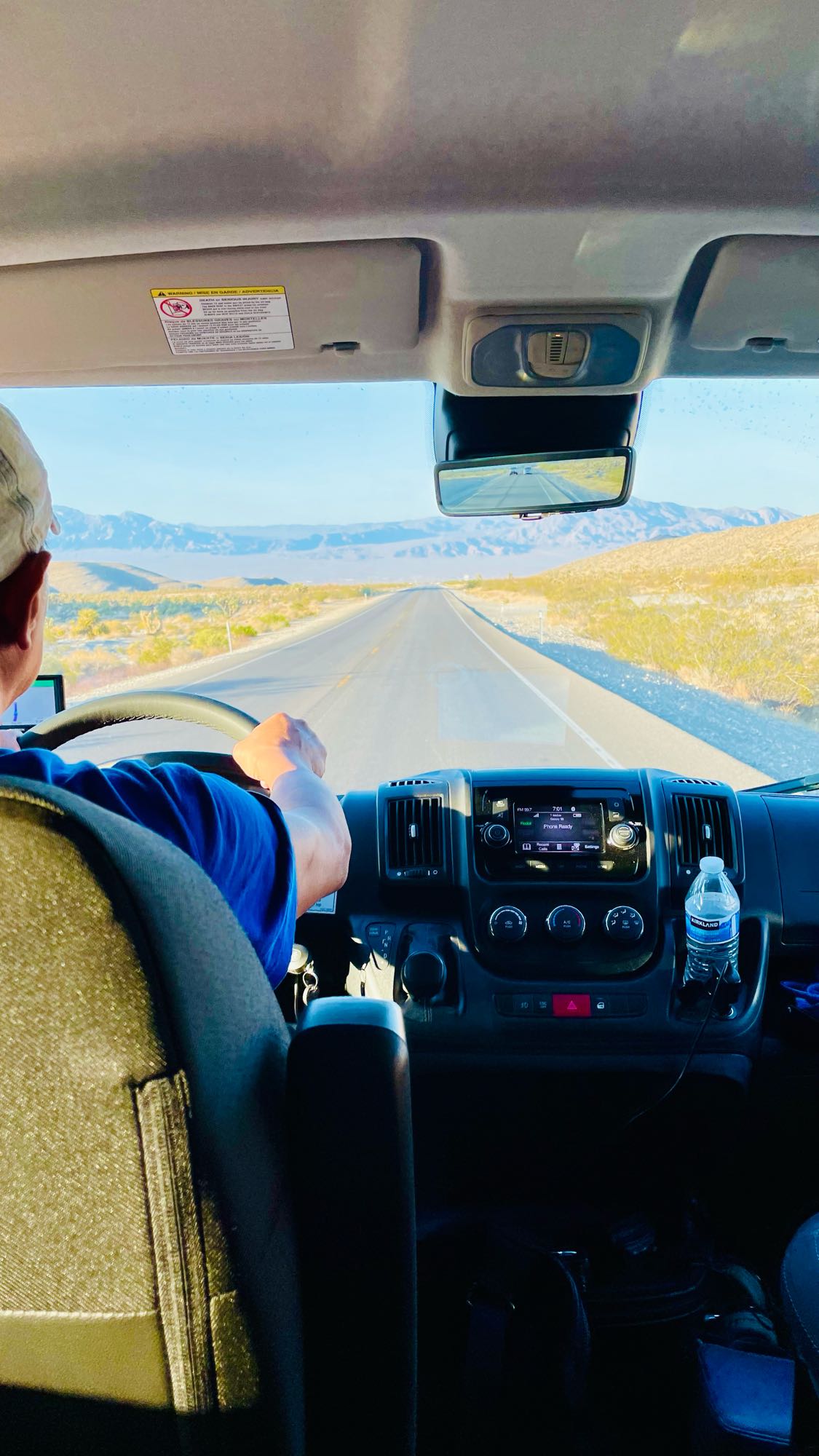  perfect for your next adventure.|Silver RV rental on a vast lake's gravelly shore under a blue sky — photo 10