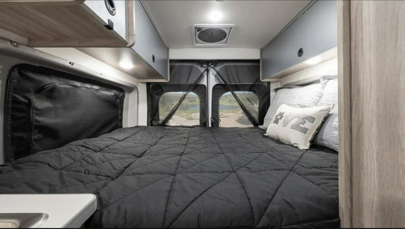  surrounded by majestic mountains and tall trees.|Inside a modern rv rental camper van showing its full kitchen — photo 4