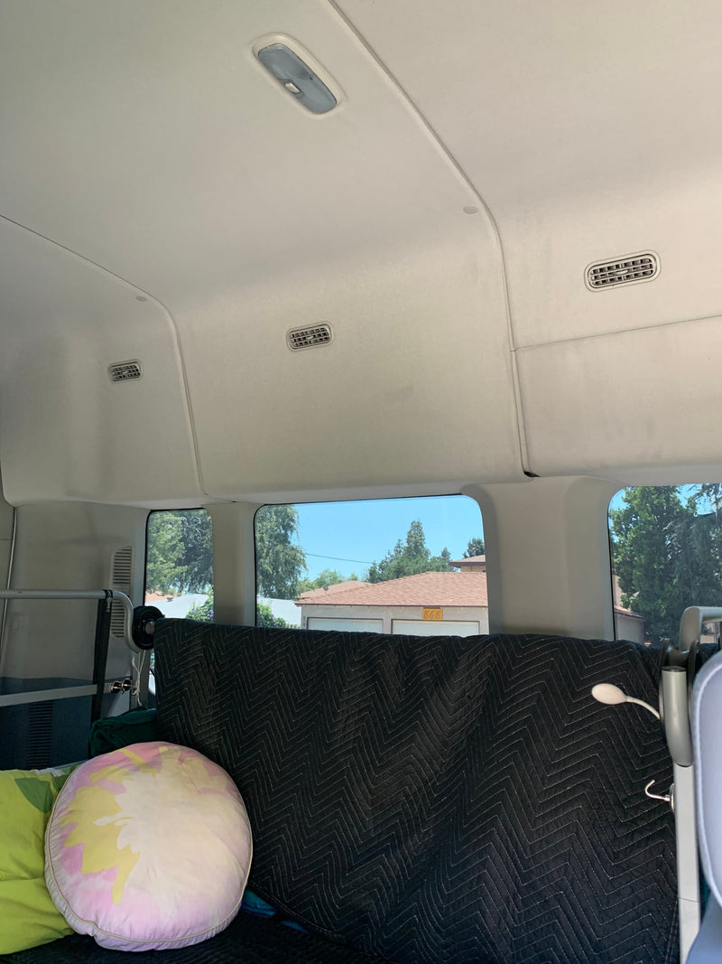  showing windows and Power Stroke badge.|Side view of a white high-roof passenger van — photo 19