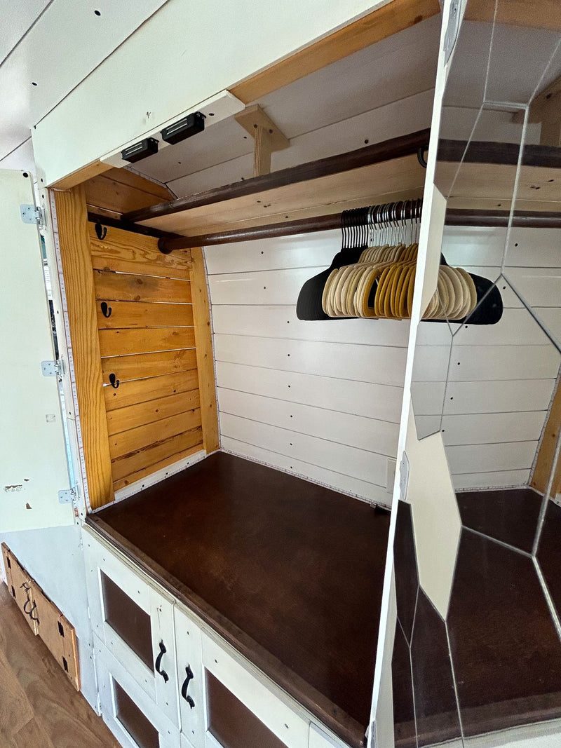  leading to a cozy seating area.|Spacious RV rental interior with a well-equipped kitchen featuring white cabinetry — photo 5