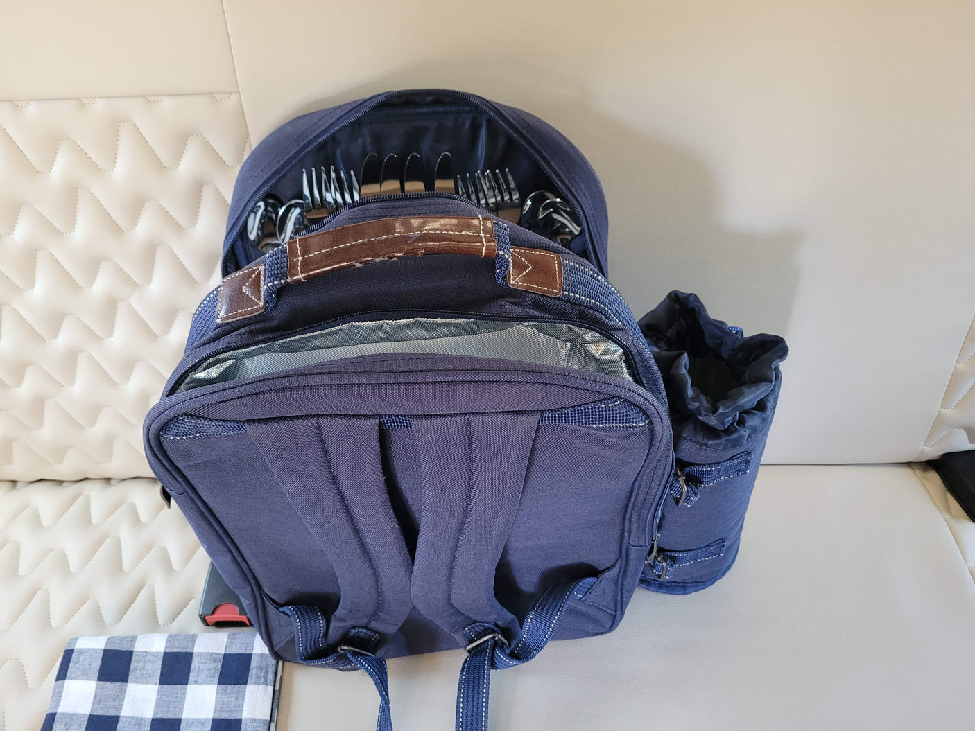 Blue picnic backpack with cutlery and blanket, ready for your RV rental adventure.