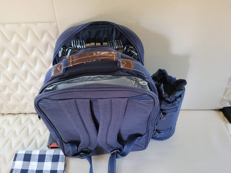 Blue picnic backpack with cutlery and blanket, ready for your RV rental adventure.