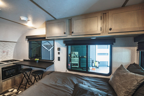 Cozy rv rental interior with a compact kitchen, comfortable sleeping area, and smart storage, perfect for your adventures.