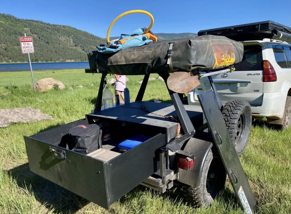  ready for camping. Get adventure-ready with an RV rental for your next trip.|An RV rental utility trailer equipped with a stand-up paddleboard (SUP) — photo 3
