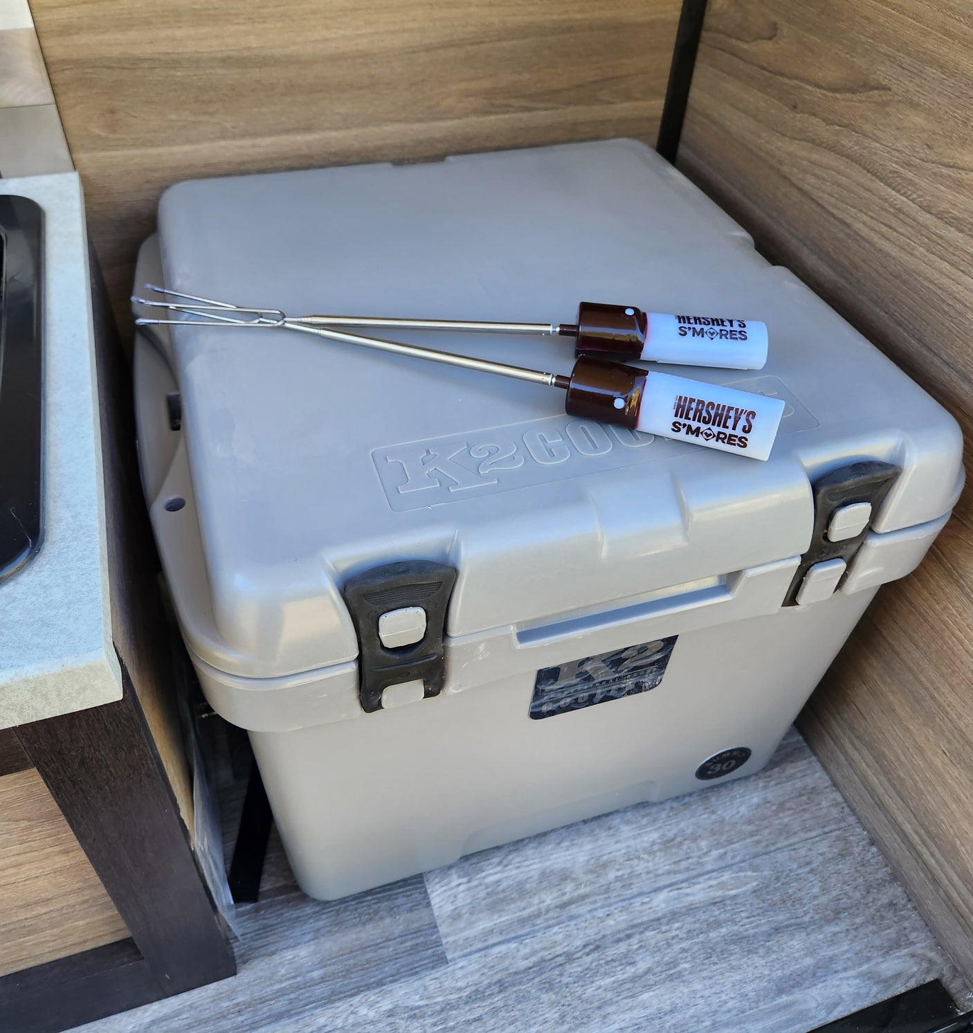Inside an RV rental: a K2 cooler topped with Hershey's S'mores roasting sticks, hinting at outdoor fun.