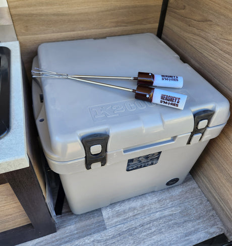 Inside an RV rental: a K2 cooler topped with Hershey's S'mores roasting sticks, hinting at outdoor fun.