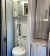 Tour this RV rental's clever compact wet bath, featuring a shower, toilet, and sink, plus built-in storage.