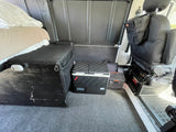 This RV rental interior offers a bed, portable fridge, Jackery power, and seat storage for comfortable travel.