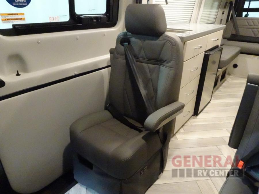  and overhead storage cabinets for compact living.|Inside an RV rental: view of the compact kitchen with sink — photo 20