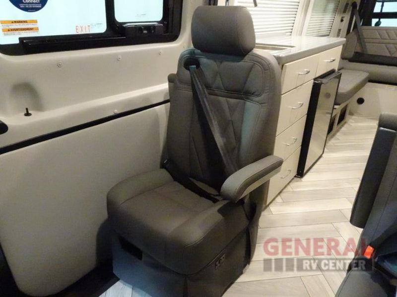  and overhead storage cabinets for compact living.|Inside an RV rental: view of the compact kitchen with sink — photo 20