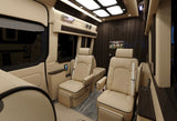 Relax in this luxurious rv rental interior with plush tan seats, dark wood paneling, and a TV, ideal for travel.