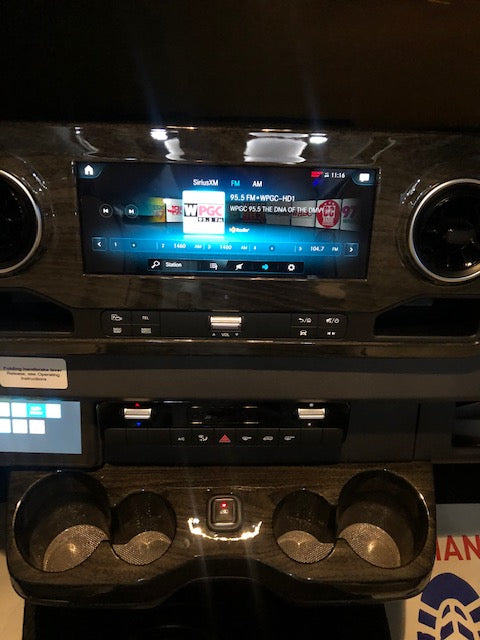 Inside an rv rental: a modern vehicle dashboard with a touchscreen radio, climate controls, and convenient cup holders. — photo 14
