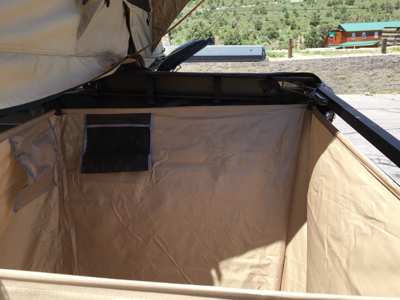  and table setup on pavement. Perfect for camping!|This RV rental setup features a dark blue minivan with an attached privacy tent — photo 7