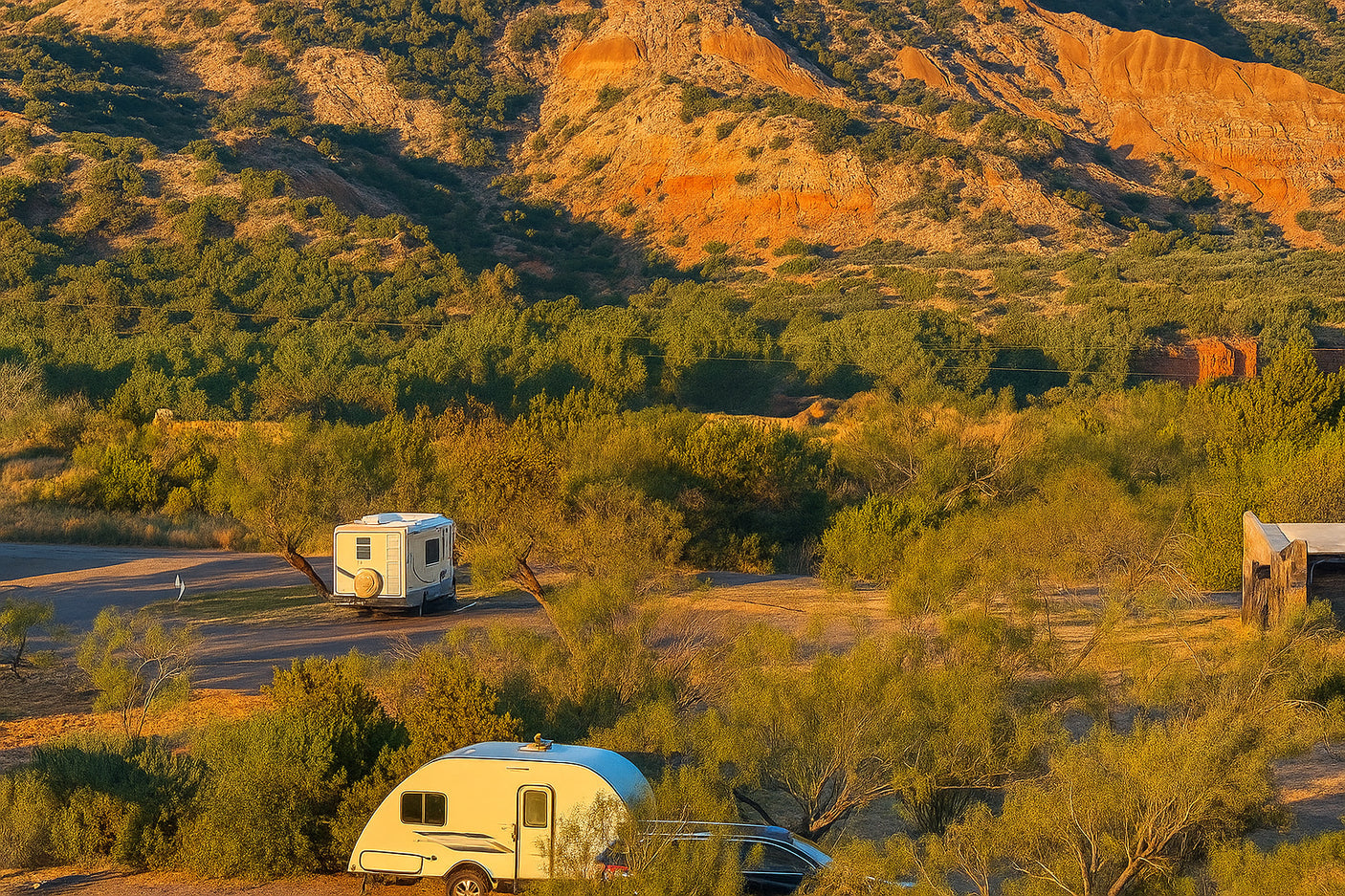 RV rental adventure in a stunning natural setting: two RVs camped amidst green foliage and vibrant red rock mountains.