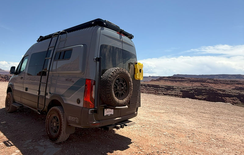  perfect for rugged canyon adventures.|Adventure-ready gray Mode 4x4 RV rental van with off-road tires — photo 4