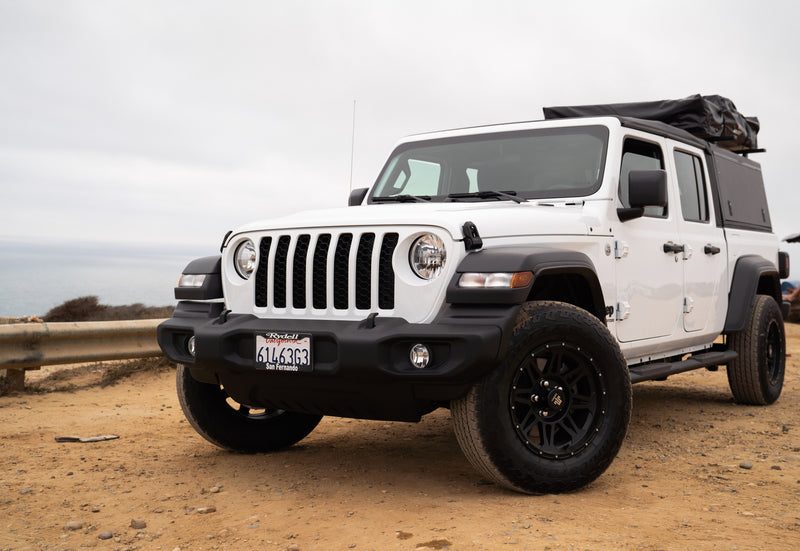 White Jeep Gladiator with rooftop tent on coastal dirt road, ready for an RV rental adventure. — photo 10